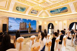 a group of people in a room with a woman on a stage at LaChateau in Ho Chi Minh City