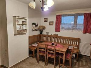 a dining room with a wooden table and chairs at Chalupa u Pepy in Tábor +10 photos