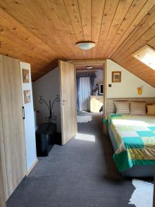 a bedroom with a bed and a wooden ceiling at Chalupa u Pepy in Tábor