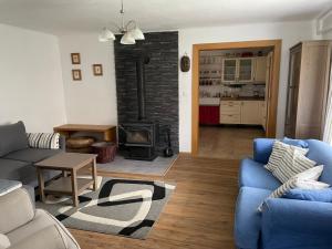 a living room with a couch and a fireplace at Chalupa u Pepy in Tábor
