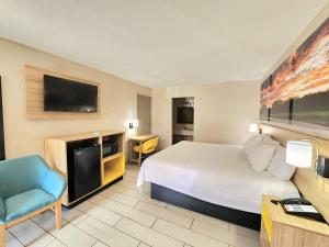 a hotel room with a bed and a television at Days Inn by Wyndham McAllen in McAllen