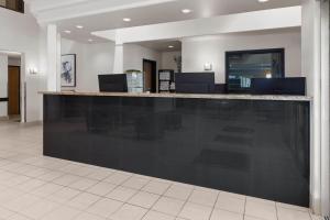 a lobby with a black counter in a building at Super 8 by Wyndham Quebec City in Quebec City +39 photos