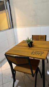 a wooden table with a potted plant on top of it at Casa63 in Lençóis +20 photos