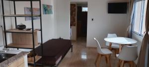 a living room with a table and a table and chairs at Balcon al dique in Las Chacras