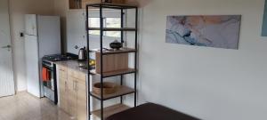 a kitchen with a shelf in the corner of a room at Balcon al dique in Las Chacras +9 photos