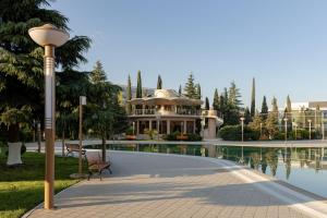 a house next to a swimming pool with a street light at Ramada Plaza by Wyndham Gence in Ganja