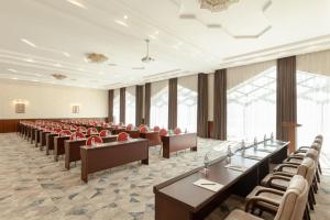 a conference room with tables and chairs and windows at Ramada Plaza by Wyndham Gence in Ganja +175 photos