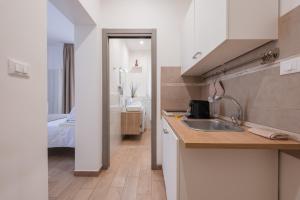 a kitchen with a sink and a bed in a room at Rooms 2Binari in Bologna +14 photos