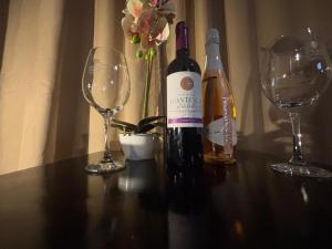 two bottles of wine and two glasses on a table at América Executive Apart Hotel Campos - LAMAG in Campos dos Goytacazes