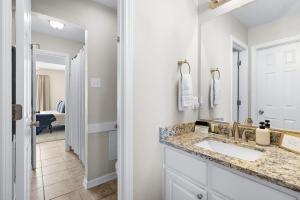 a bathroom with a sink and a mirror at Spacious 2BR House, Steps from A&M - King - Patio in College Station