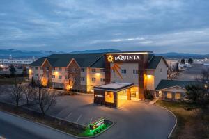 a hotel with a sign on the front of a building at La Quinta by Wyndham Spokane Valley in Spokane Valley