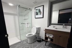 a bathroom with a shower and a toilet and a sink at La Quinta Inn by Wyndham Salt Lake City Midvale in Midvale