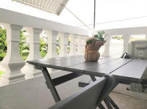 a table on a porch with a potted plant on it at Chill Haven in Kingston