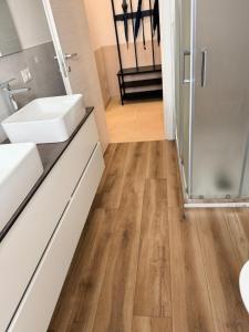 a bathroom with a sink and a shower at Melannie's Apartment 2 in Bergamo +54 photos