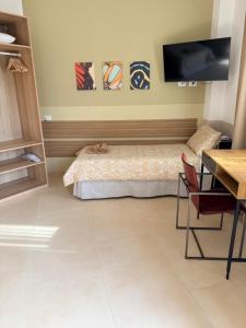 a bedroom with a bed with a cat sleeping on it at Melannie's Apartment 2 in Bergamo