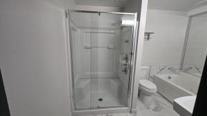 a shower with a glass door in a bathroom at Roosevelt Inn at Roosevelt Blvd, Philadelphia, PA in Philadelphia
