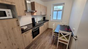 a small kitchen with a table and a microwave at Hof Hahnenberg in Wagenfeld +19 photos