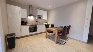 a kitchen and dining room with a table and chairs at Hof Hahnenberg in Wagenfeld