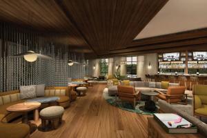 a lobby with couches and tables and a bar at The Greenleigh, River Oaks, Autograph Collection in Houston