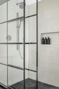 a shower with a glass door in a bathroom at The Greenleigh, River Oaks, Autograph Collection in Houston +27 photos