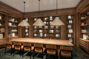a large room with a large wooden table and chairs at The Greenleigh, River Oaks, Autograph Collection in Houston