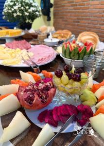 a table topped with lots of different types of food at Pousada Sabiá in Brotas
