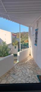a view of a white building with a stone floor at Casa dos Avós Palma - Alcoutim in Alcoutim