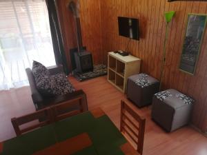 a living room with a couch and a stove at Cabañas Biancomoro Olmue in Olmué