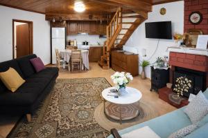 a living room with a couch and a table at Archontiko Kastellia - Stone Guesthouse with Fireplace and Mountain View in Evangelístria