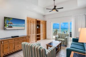 a living room with a couch and chairs at The Reef Beach Resort, East End, Grand Cayman in Sand Bluff