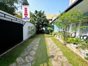 a walkway in a yard next to a house at The Duchess Hotel in Matara