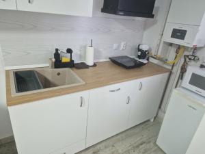 a kitchen counter with a sink and a microwave at City Studio in Târgu Secuiesc