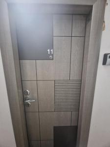 a door in a room with a tile wall at City Studio in Târgu Secuiesc