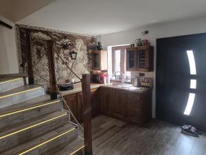 a kitchen with wooden cabinets and a counter top at Vinný sklípek u Dědy in Hrušky