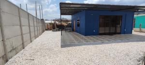 a blue building with a door on the side of it at Casa Roma in Chorro +4 photos