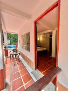 a door to a patio with a table and a room at Manigua Tayrona Hostel in Santa Marta