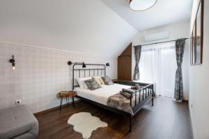 a bedroom with a bed and a couch at Hébér Ház in Románd