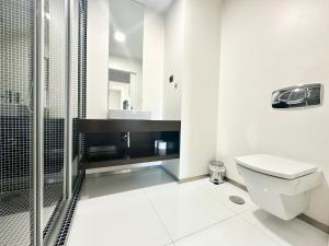 a white bathroom with a toilet and a shower at Precious Relaxation Rooms in Funchal in Funchal