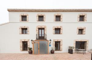 an old door in front of a white building at Hotel Caseta Nova in Castalla