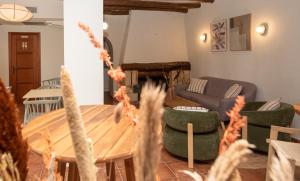 a living room with a wooden table and green chairs at Hotel Caseta Nova in Castalla