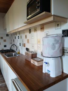 a kitchen with a counter top with a sink and aounter at Cabaña la Monita in Tandil +8 photos