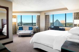 a hotel room with a bed and a large window at Memphis Riverline Hotel in Memphis