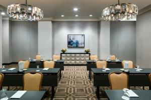 a conference room with tables and chairs and chandeliers at Memphis Riverline Hotel in Memphis