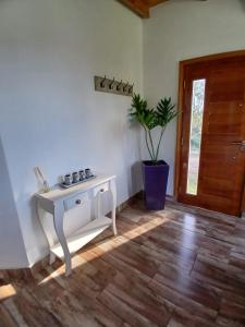 a room with a white table and a potted plant at Cabaña la Monita in Tandil