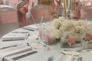 a table with white and pink flowers on it at Memphis Riverline Hotel in Memphis