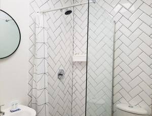 a bathroom with a shower and a toilet at Chill Haven in Kingston +28 photos