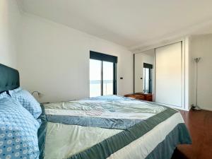 a bedroom with a bed and a large window at Precious Relaxation Rooms in Funchal in Funchal