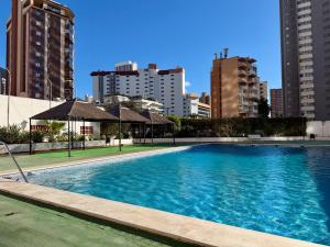 a large swimming pool in a city with tall buildings at Apartments 1 & 2 Bedrooms, Gemelos 2 & 4, Levante Beach by Gestaltur in Benidorm