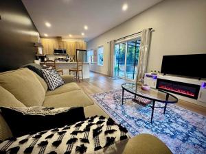 a living room with a couch and a table at Island Coastal Retreat in Nanaimo