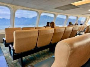 a row of seats on an airplane with people sitting at Island Coastal Retreat in Nanaimo